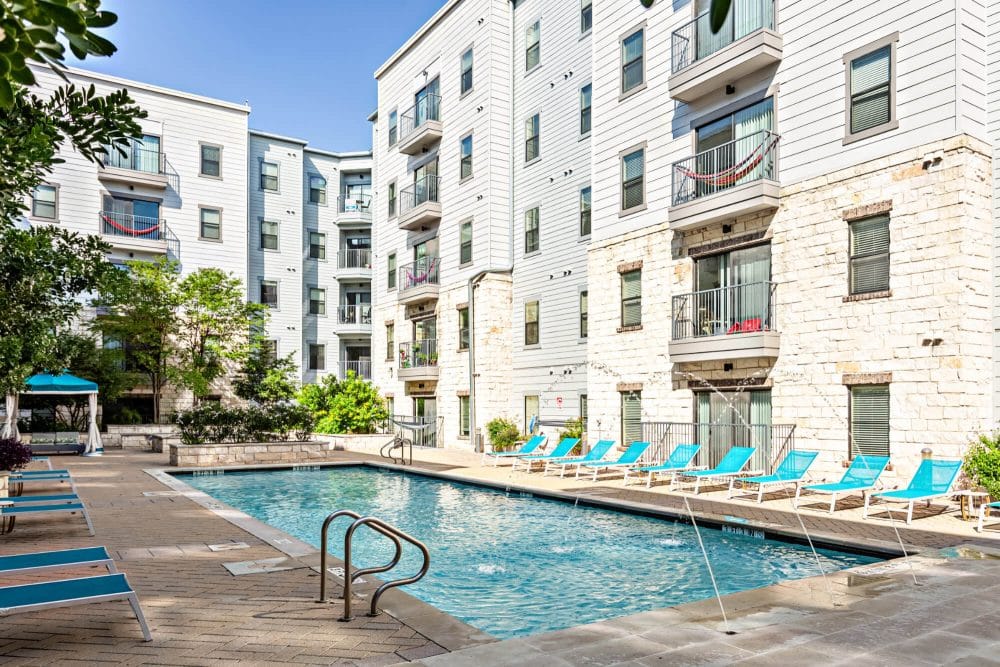 axis west campus off campus apartments in west campus near ut austin resort style pool building exterior balconies